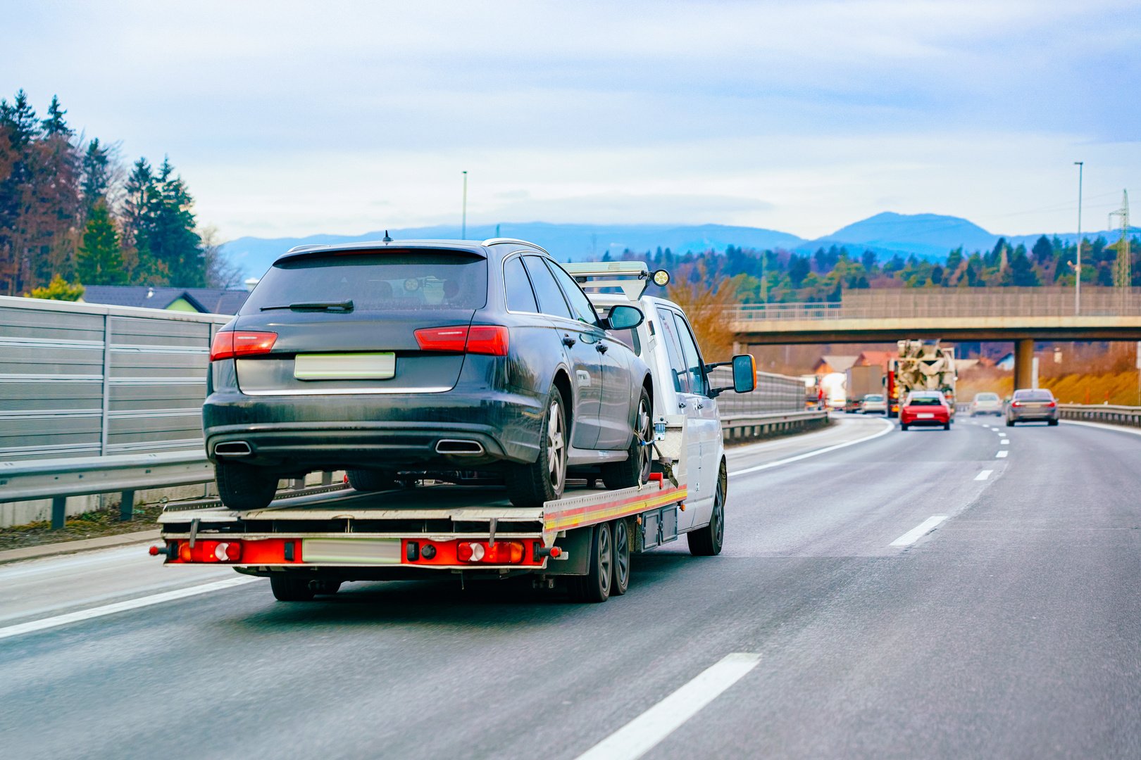 Tow Truck with Car on a Highway